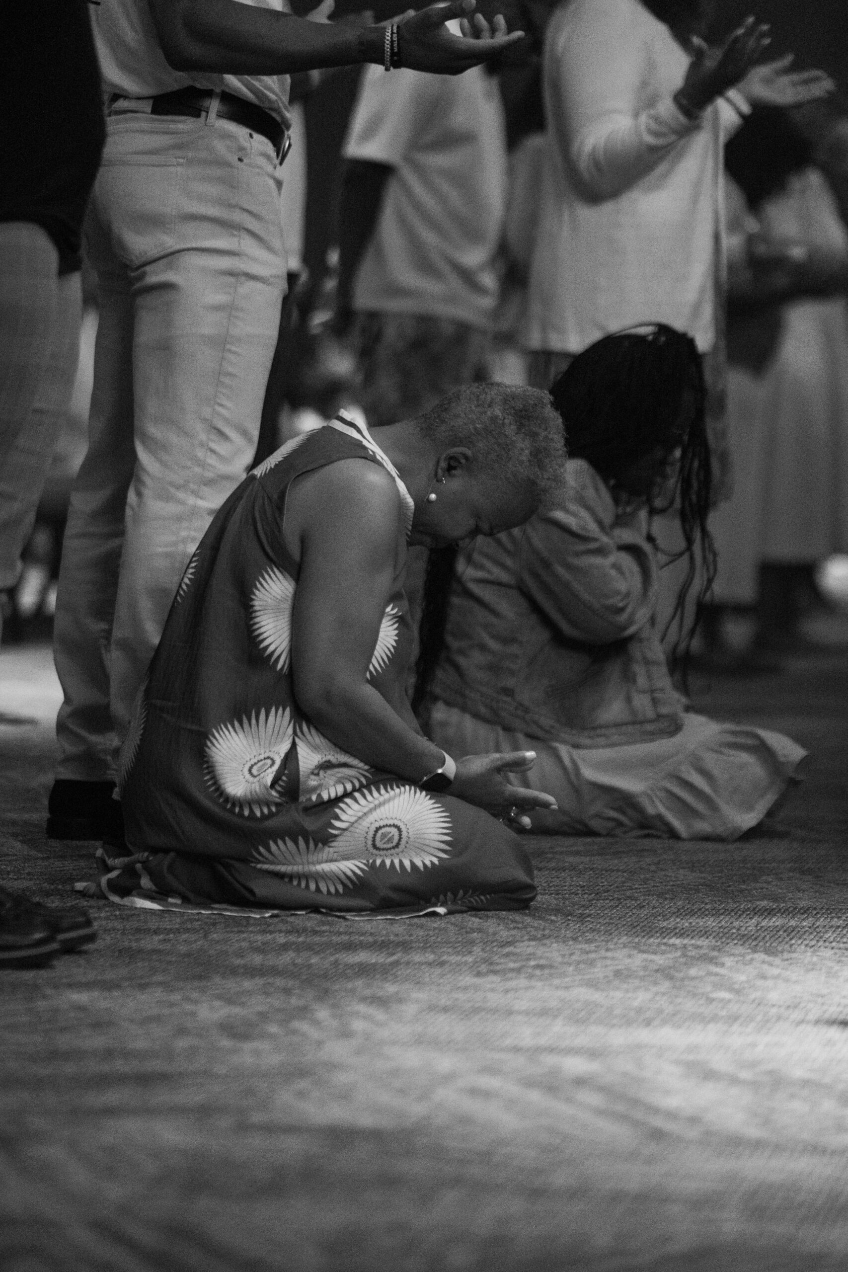 Women kneeling together in prayer during a church gathering