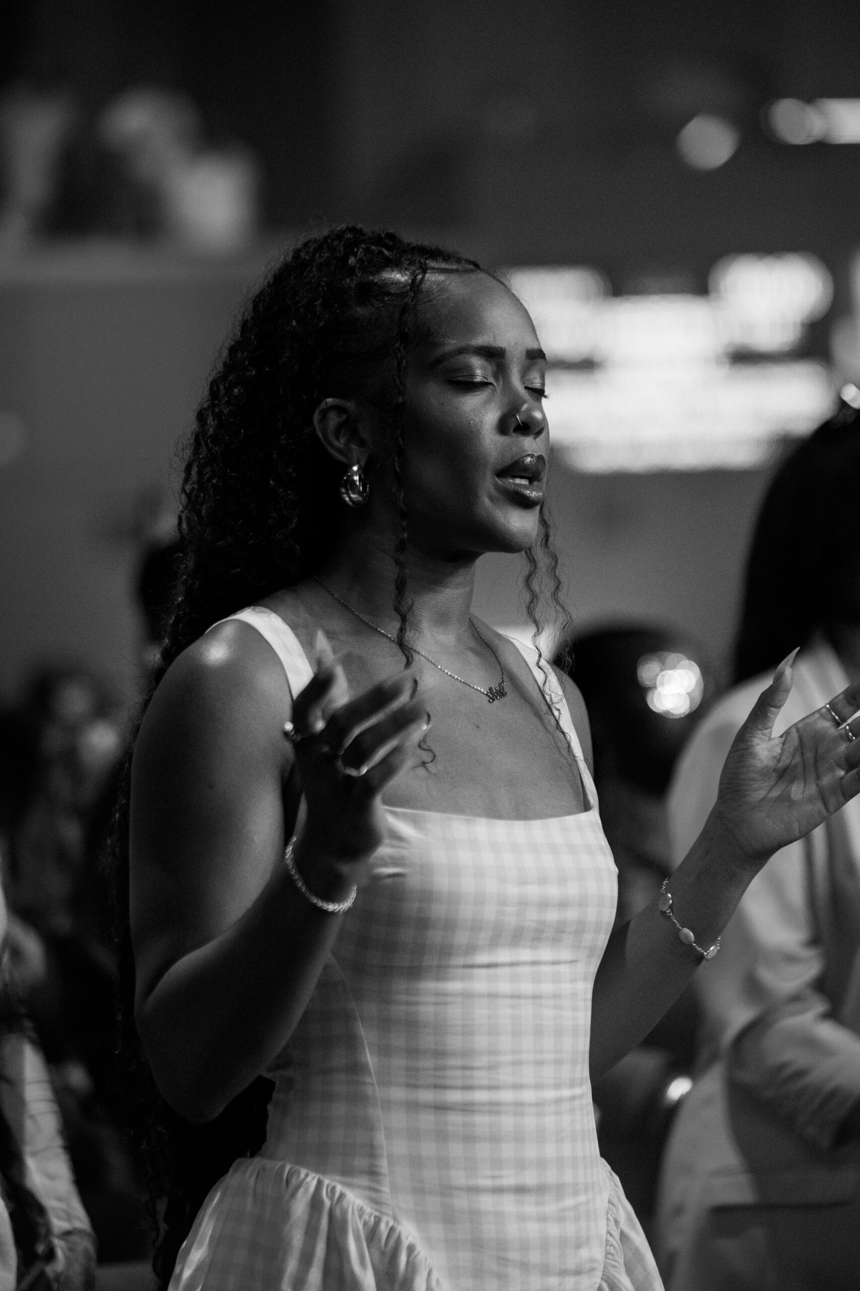 Woman worshipping with her eyes closed and hands raised